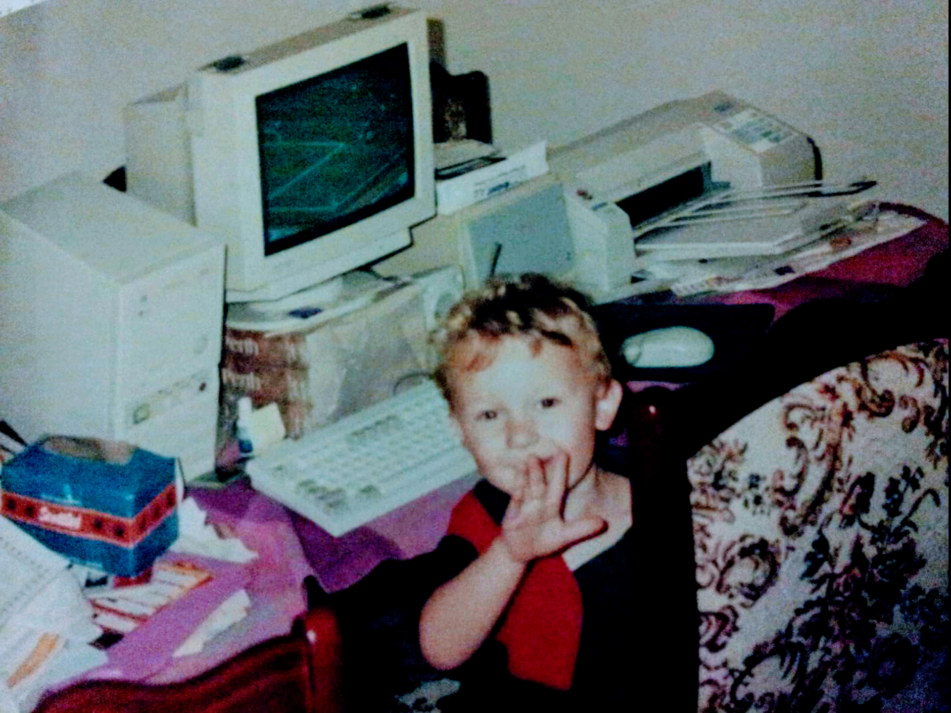 Alister as a child at an old computer